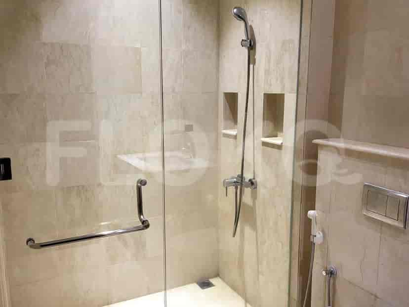Bathroom with a shower area featuring a shower head and glass door.