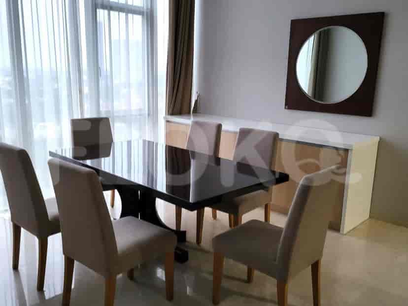 Dining area with a black dining table and six chairs, with a mirror and cabinet.
