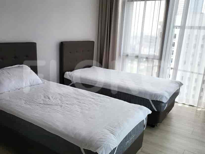 Bedroom with two twin beds, each with a headboard, and curtains.