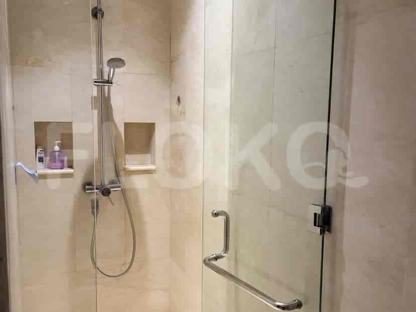Bathroom with a shower, glass door, and a simple design.