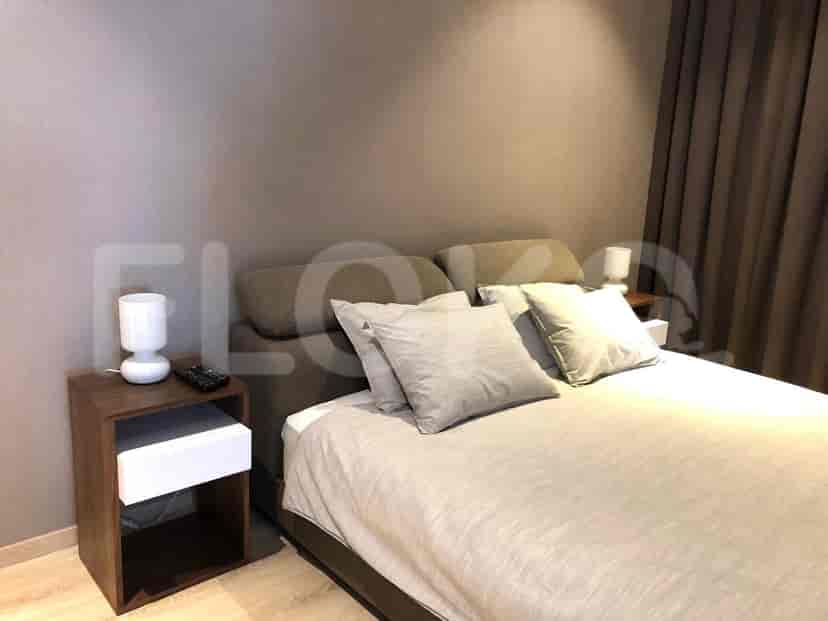 A cozy bedroom featuring a bed, nightstands, and lamps.