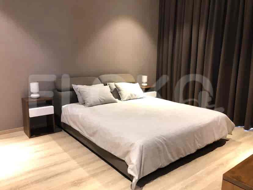 A modern bedroom setup with a bed, nightstands, and curtains.