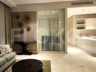 A living room with a sofa, coffee table, and decorative wall.