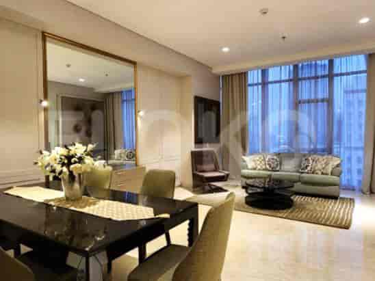 A dining area with a table, chairs, and a large mirror.