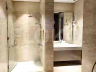 A modern bathroom with a shower, sink, and mirror.