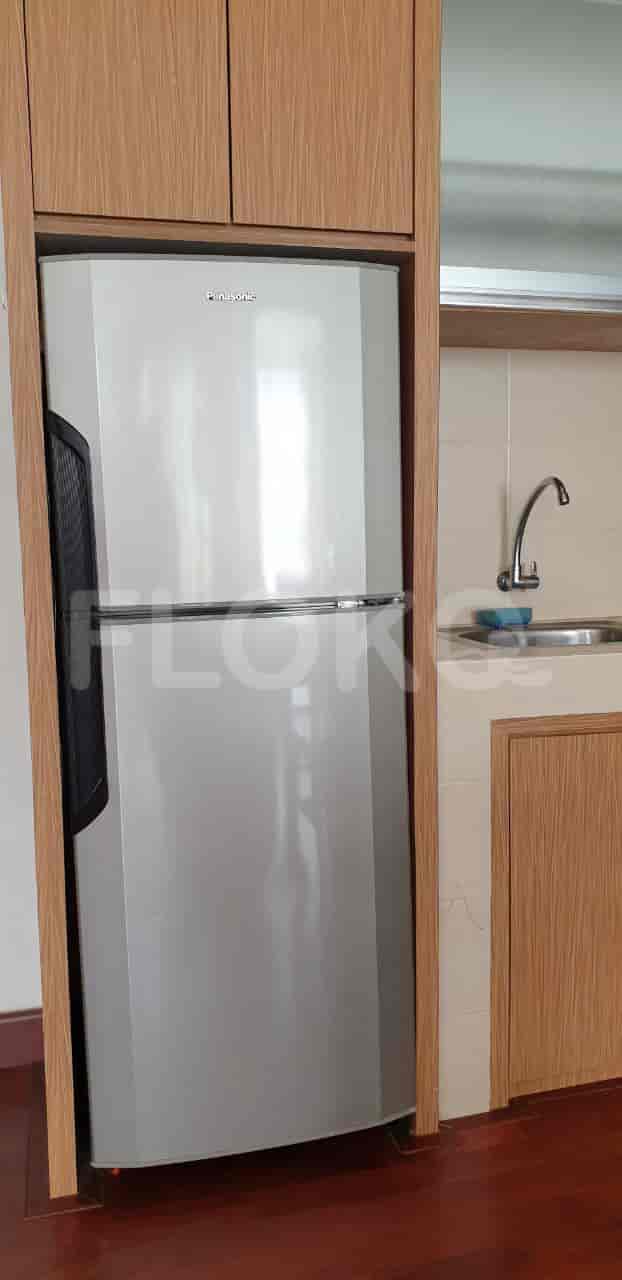 A bathroom with a shower, toilet and water heater