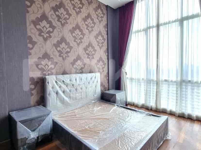 Bedroom with a bed, nightstands, and patterned wallpaper.