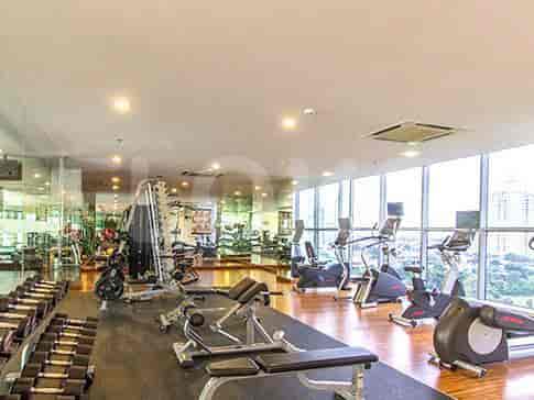 Fully equipped gym with a variety of exercise machines and weights.