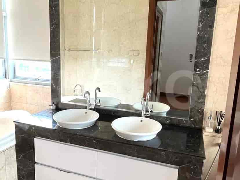 Bathroom with double vanity, marble countertops, and large mirror.