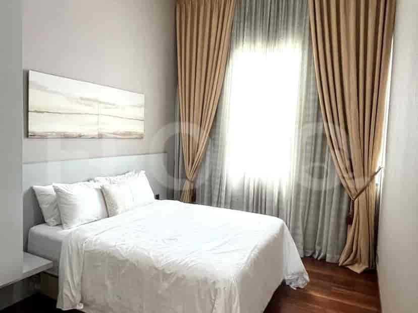 Bedroom with queen-sized bed, white bedding, and light-colored curtains.