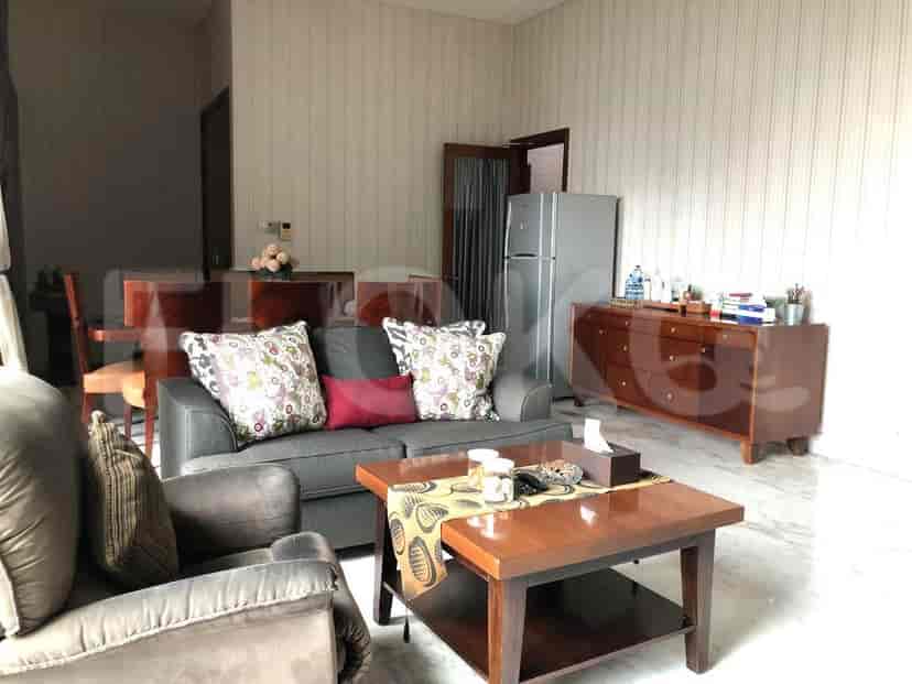 Living room with grey sofa, coffee table, and wooden cabinet.