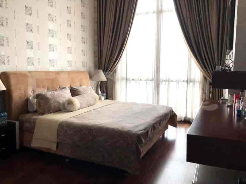 Bedroom with a bed and curtains.