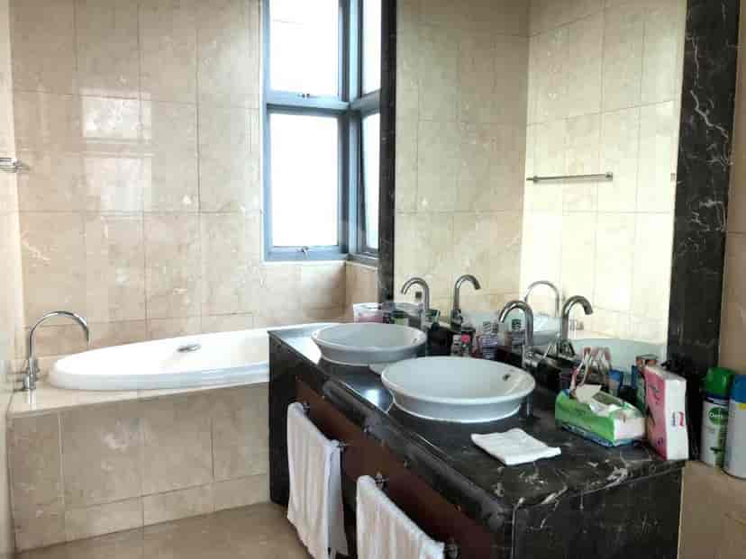 Bathroom with a bathtub and double sinks.