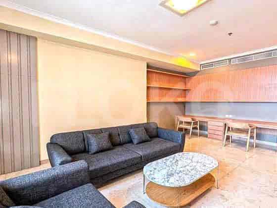 Living room and study with a sofa, coffee table, and built in study area.