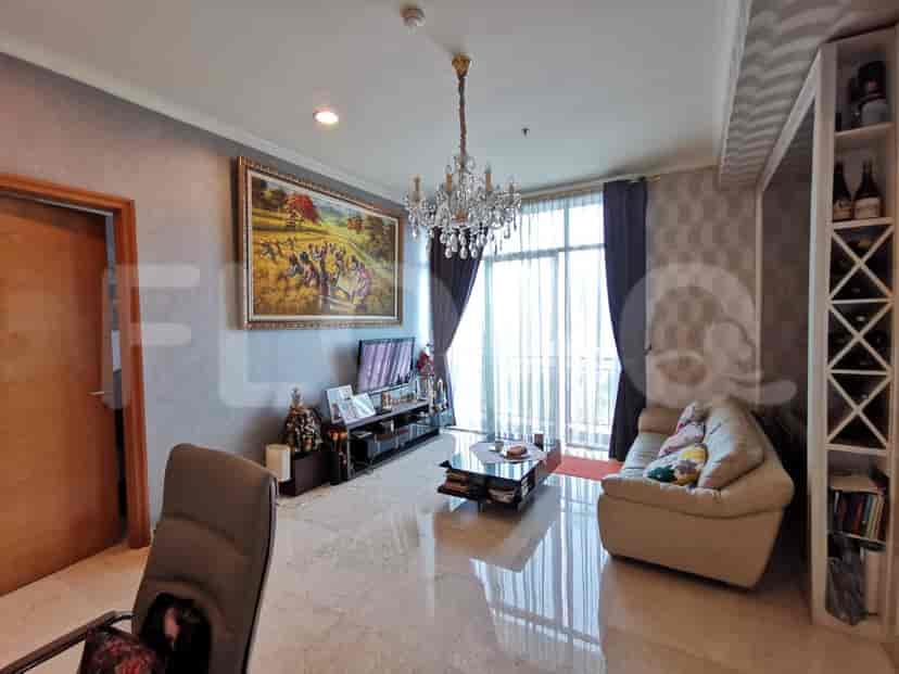 Living room with large art, sofa, and chandelier.