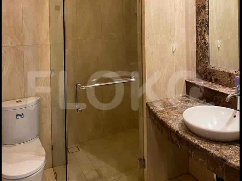 Modern bathroom featuring a glass-enclosed shower and a marble vanity.