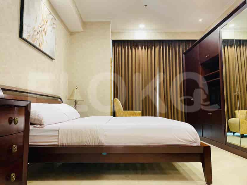 A spacious bedroom with a double bed and a large wardrobe.