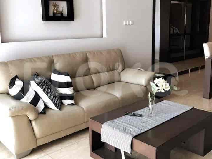 Cozy living room with a beige sofa, coffee table, and decorative pillows.