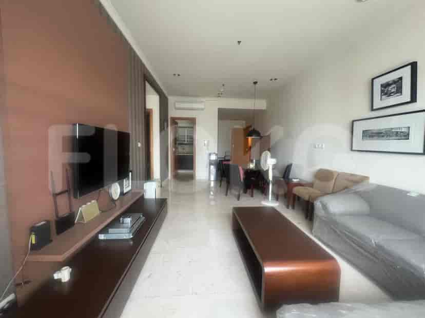 Spacious living room with TV, coffee table, and dining area.