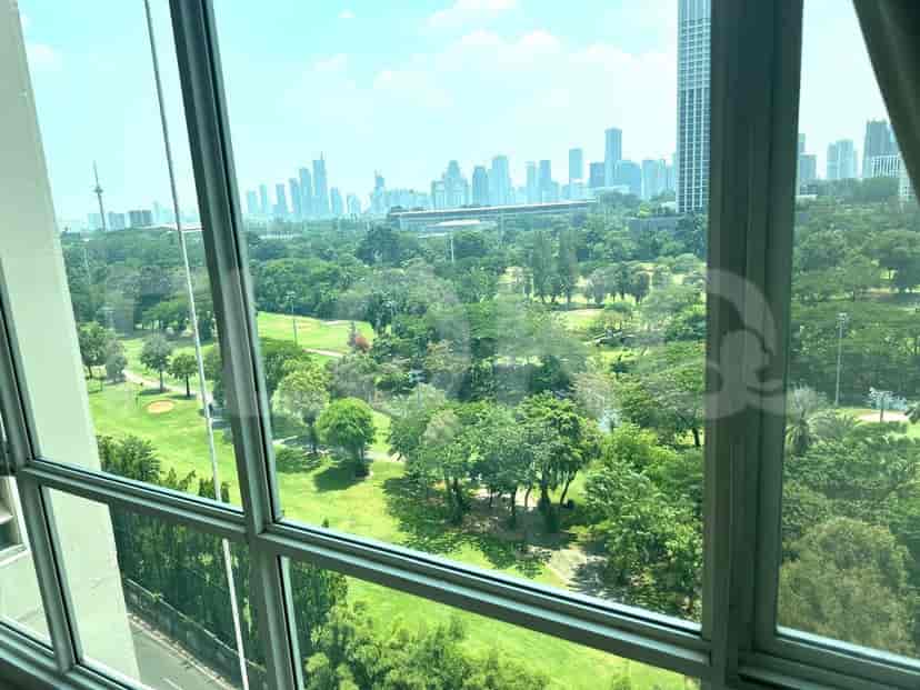 View of the city and golf course from a window.