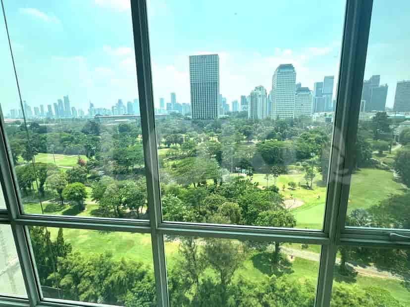 View of the city and golf course from a window.