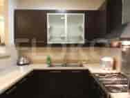 A modern kitchen with cabinets, sink, and stove.