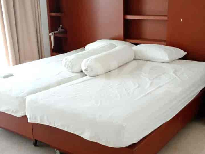 A bedroom featuring two single beds with headboard.