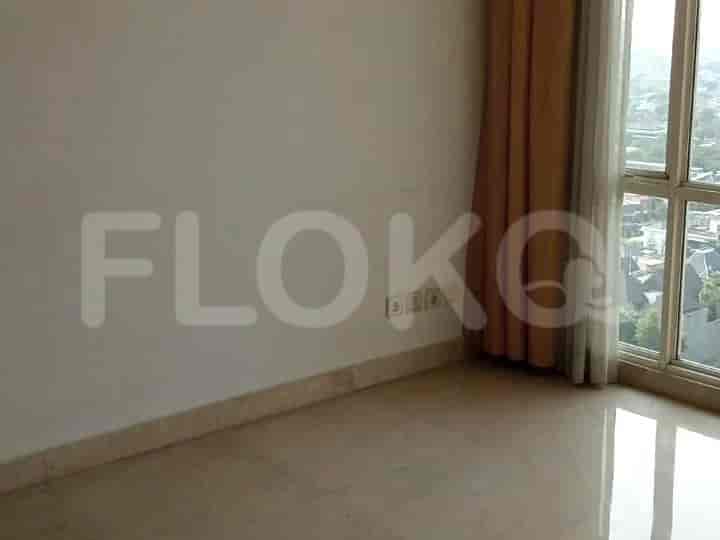 An empty room with a window and curtains.