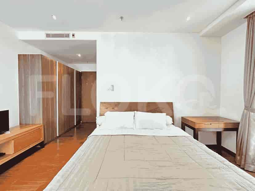 Another bedroom showcasing a bed, a wooden console, and a large closet.