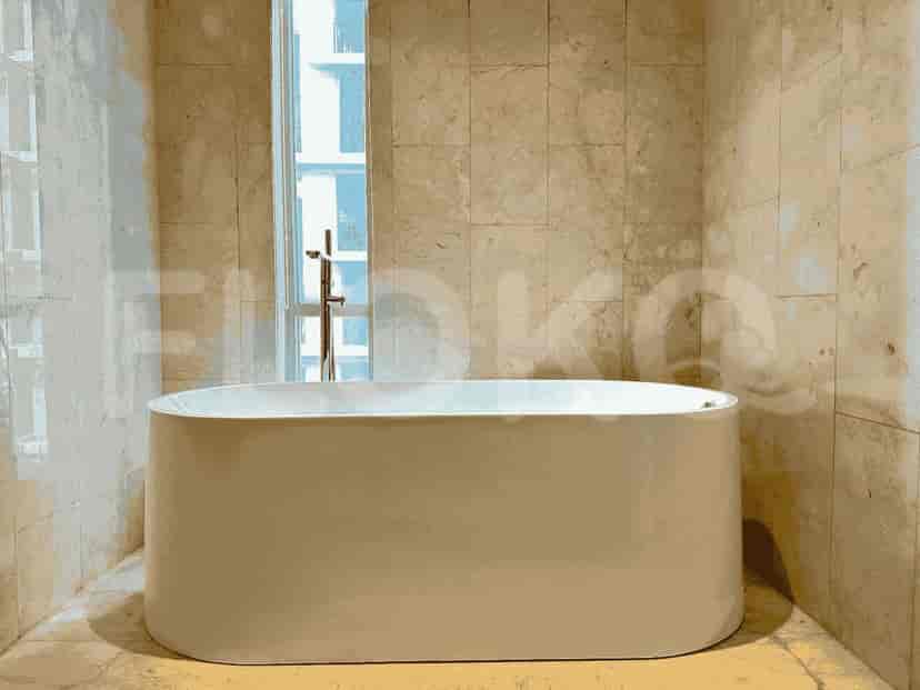 A bathroom with a bathtub and a window.