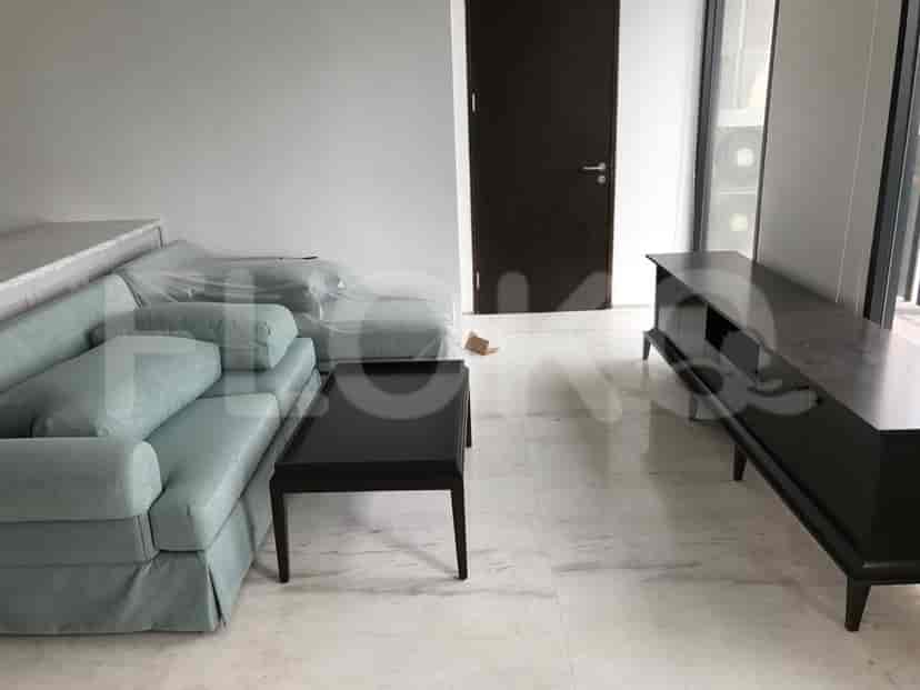 Living room featuring a blue sofa, a dark brown coffee table, and a dark brown TV console.
