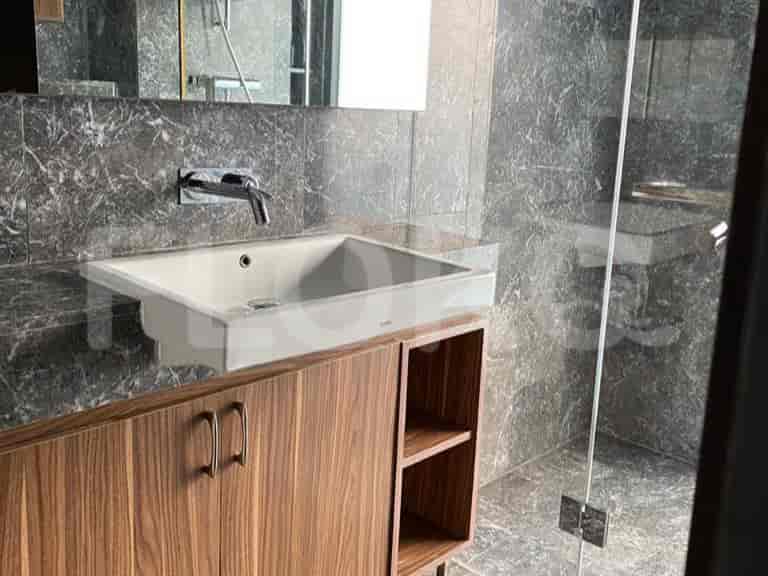 Modern bathroom with a sink, vanity, and glass shower.