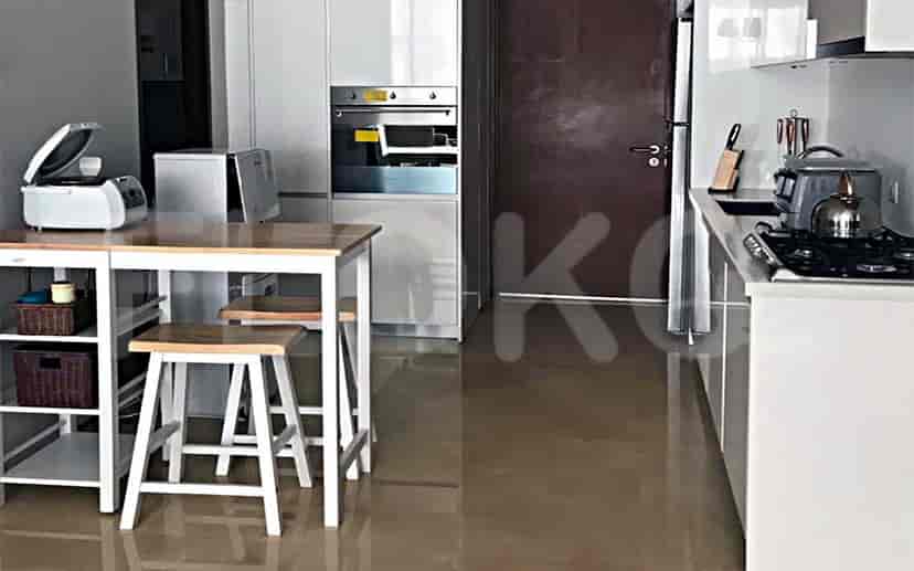A well-equipped kitchen with white cabinets, a wooden island, and modern appliances.