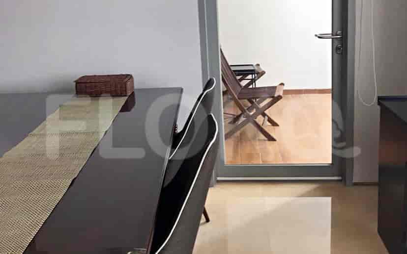 Dining area with table and view to the balcony.