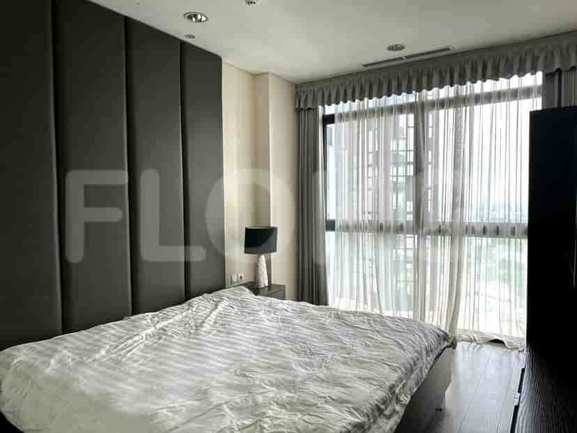 Bedroom with bed, headboard, and window.