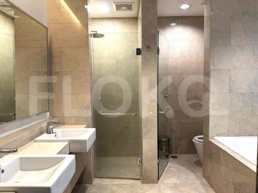 A bathroom with a glass shower, sink, and mirror.