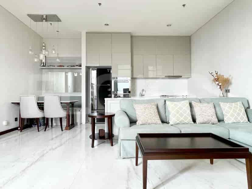 Living and dining area featuring a modern design, open kitchen, and dining table set with chairs.