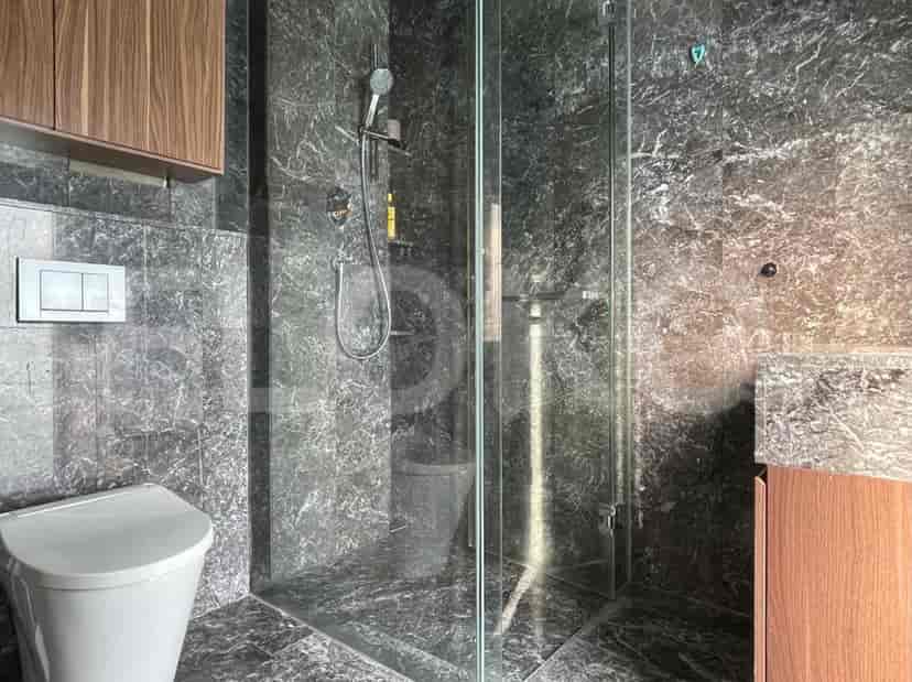 Modern bathroom with a dark marble design, glass shower, and wooden cabinet.
