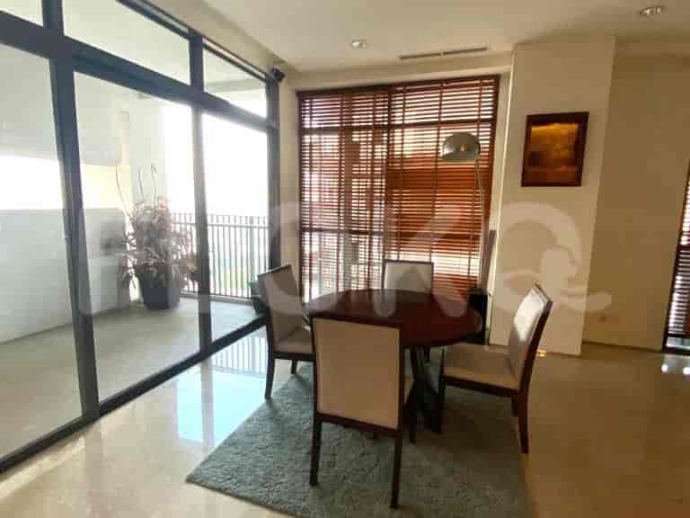 Dining area with a circular table and chairs overlooking the balcony.