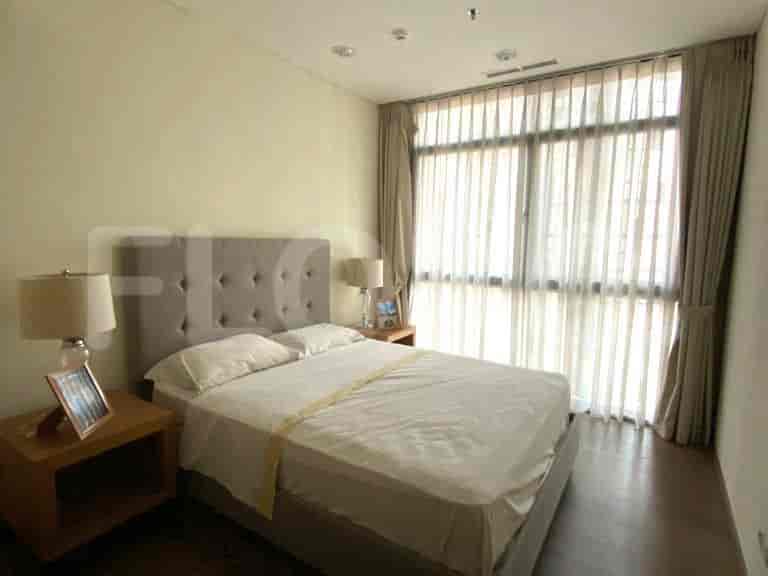 The bedroom features a bed, and lamps.