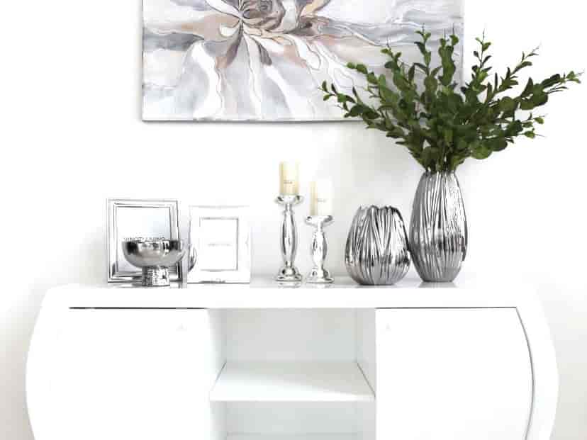 White cabinet with decorative objects.