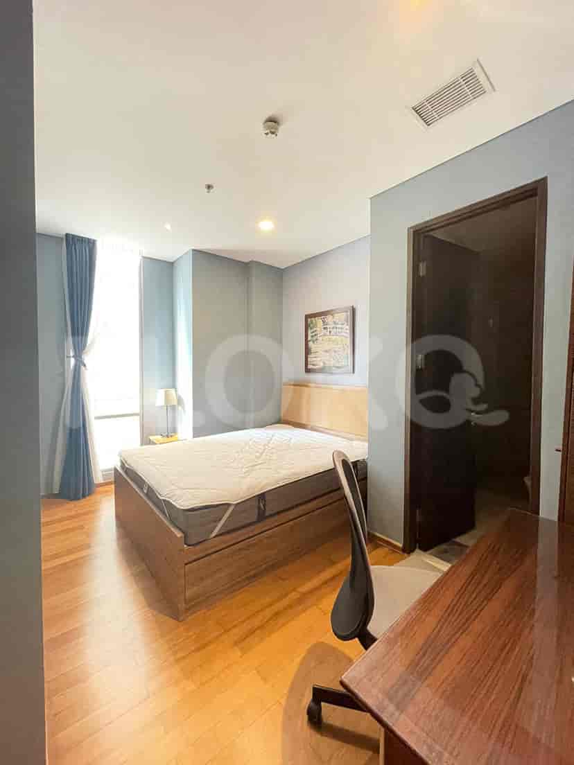 Bedroom with a bed, study desk, and a bathroom access.