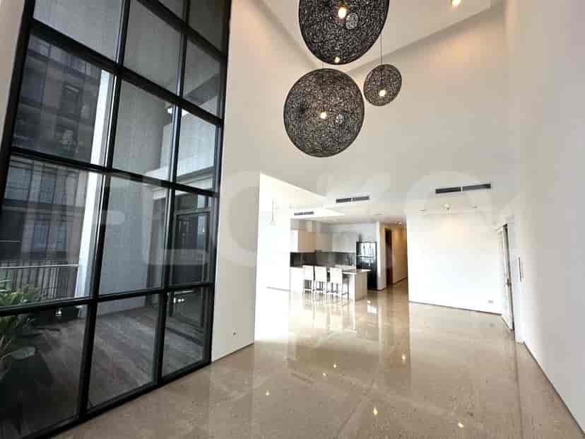 Living room with floor-to-ceiling windows and pendant lights.