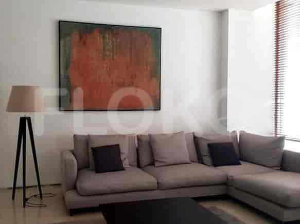 Living room with a modern sofa, art, and a floor lamp.