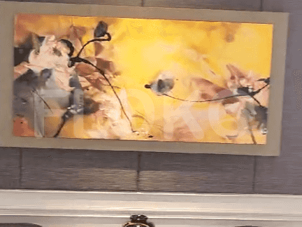 Artwork above a white base, with a neutral color palette.
