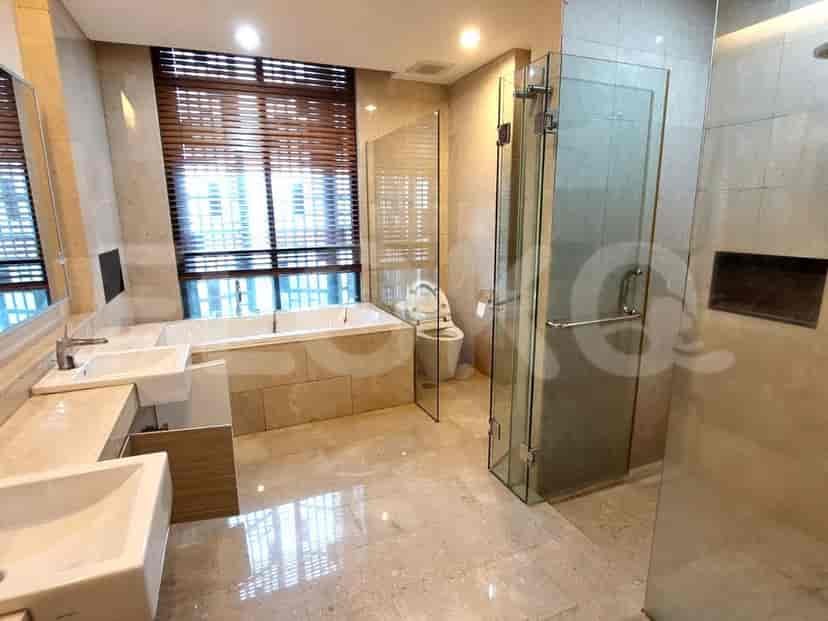 Luxurious bathroom with marble floor, bathtub, and glass shower.