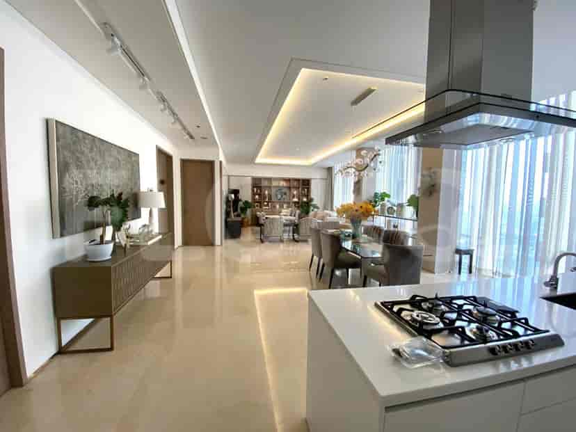Spacious, modern living area with a kitchen island, marble floors, and elegant lighting.