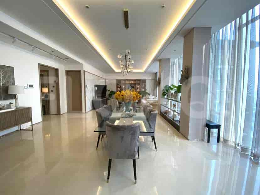 Hallway with decorative wall art, console table, and warm lighting.