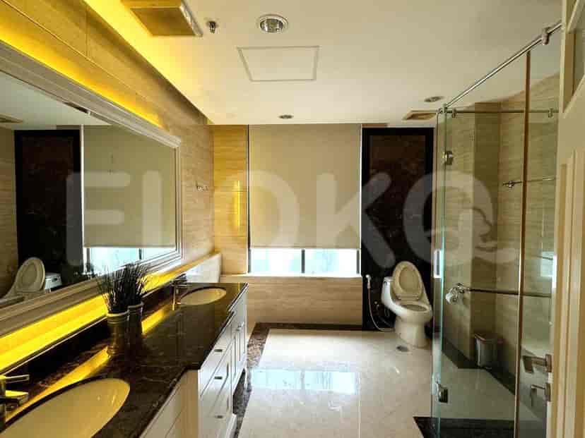 Modern bathroom with double vanity, glass shower, and neutral tones.