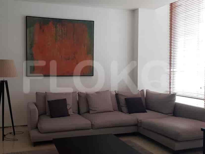 A contemporary living room with a grey sectional sofa and abstract art.